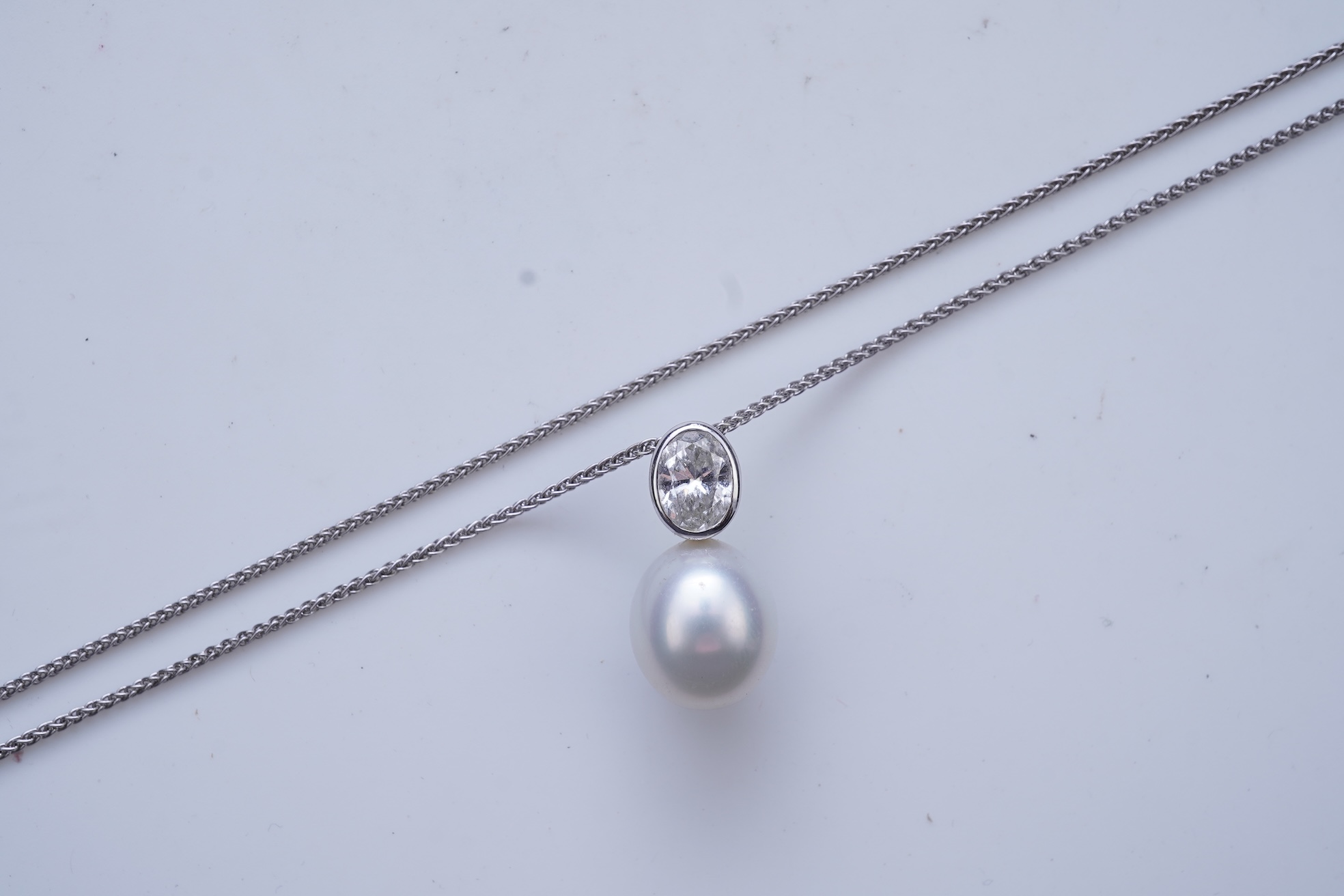 A cultured pearl and diamond pendant